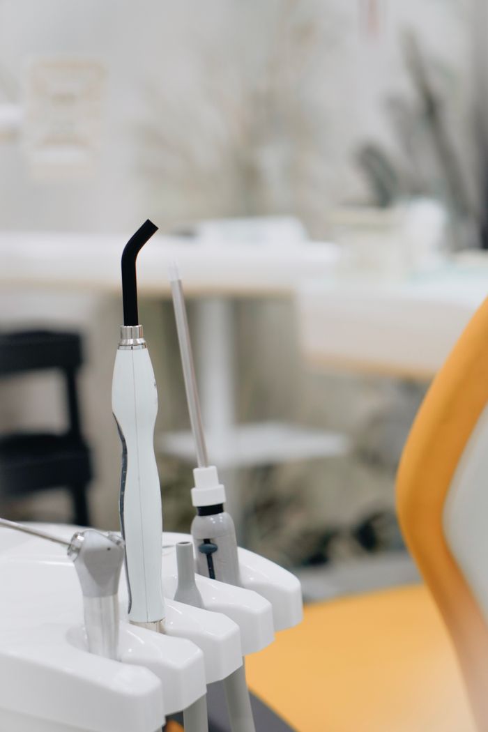 Close-up view of dental tools in a modern clinic setting, focused on equipment.